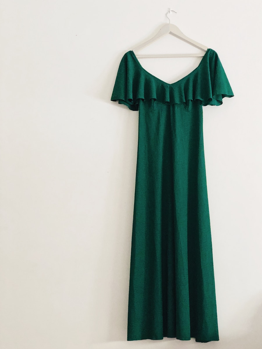 green sleeveless dress hanged on white wall